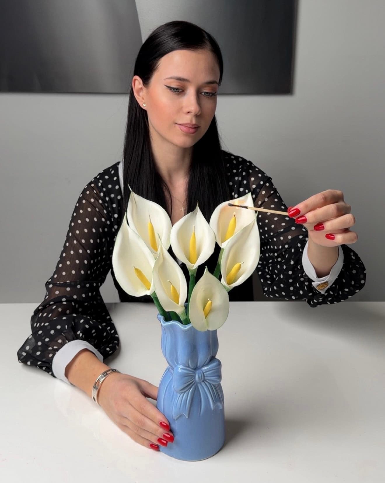 Lighting a bouquet of white calla lily candles